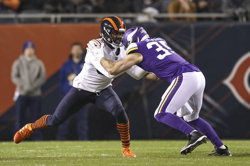 Chicago Bears outside linebacker Robert Quinn tries to shed a block by Minnesota Vikings tight end Luke Stocker during their game Dec. 20, 2021, in Chicago.