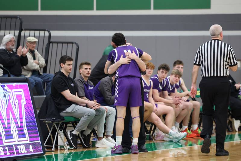 Wilmington head coach Doug Krop hugs senior Ryan Kettman as he leaves the court during Bishop McNamara's 61-24 victory over Wilmington in the IHSA Class 2A Seneca Sectional semifinal on Tuesday, March 3, 2026.