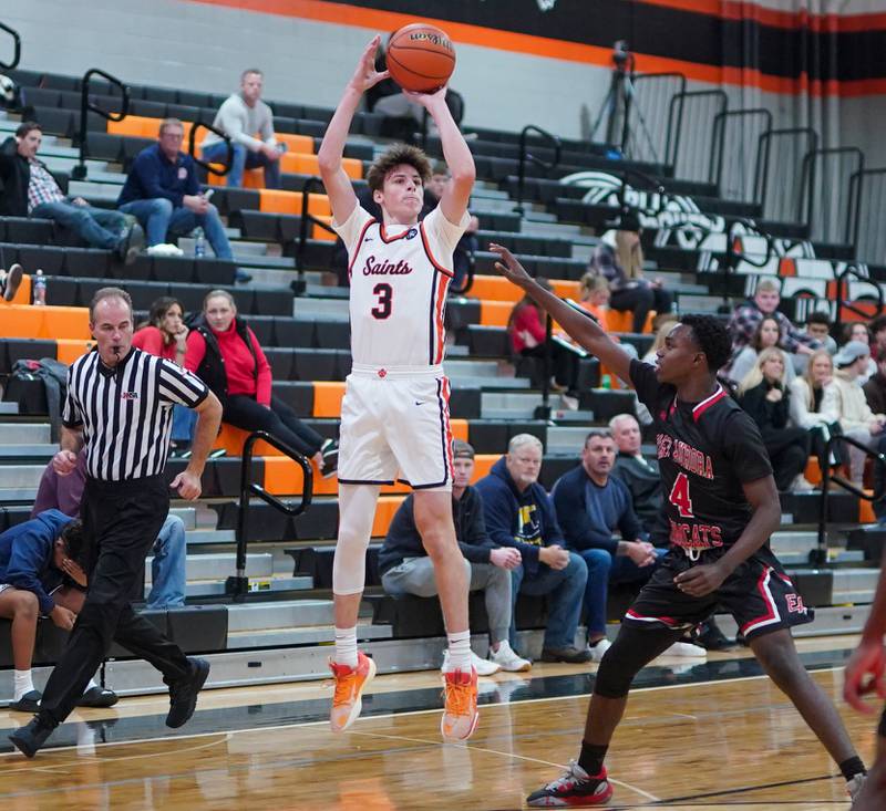 St. Charles East's Marco Klebosits (3) shoots a three pointer against East Aurora's Kenneth Cooley (4) during the 64th annual Ron Johnson Thanksgiving Basketball Tournament at St. Charles East High School on Monday, Nov 20, 2023.