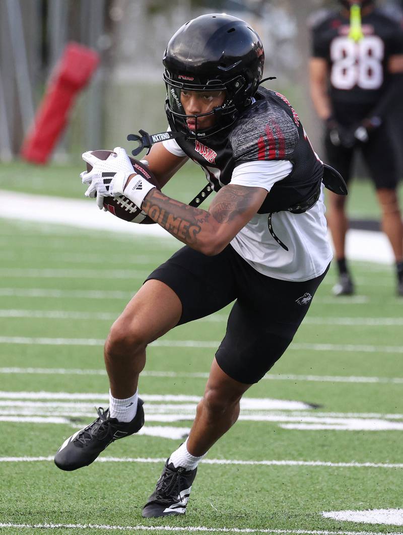 Northern Illinois University wide receiver Kevin Holmes Jr. looks to run after a reception Tuesday, April 14, 2026, during spring practice in Huskie Stadium at NIU in DeKalb.