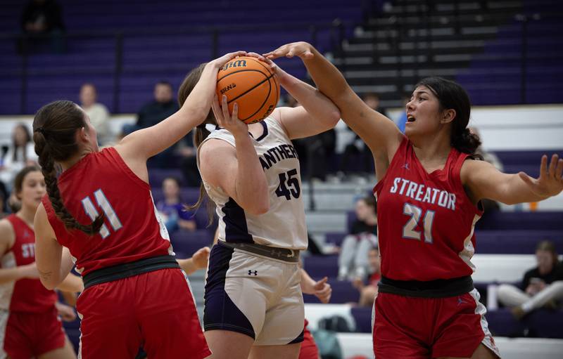 Streator's Alexis Thomas, right, and Ava Gwaltney, left, defend a shot from Manteno's Emily Horath, center, in a game on Monday, December 8, 2025.