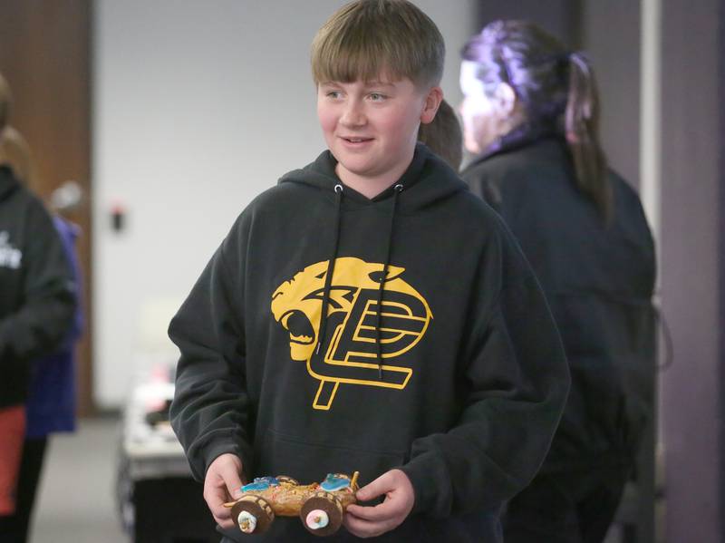 Mason King of Putnam County Junior High School, carries his edible car to the starting line during the 29th annual Edible Car Contest on Wednesday, Feb. 26, 2025 in the cafeteria at Illinois Valley Community College.
