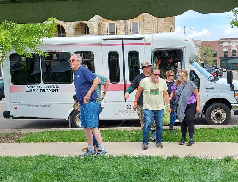 Midwest Morel Fest hunters in Ottawa step off a bus at the Jordan block following the hunt at a secret location Saturday, May 4, 2024.