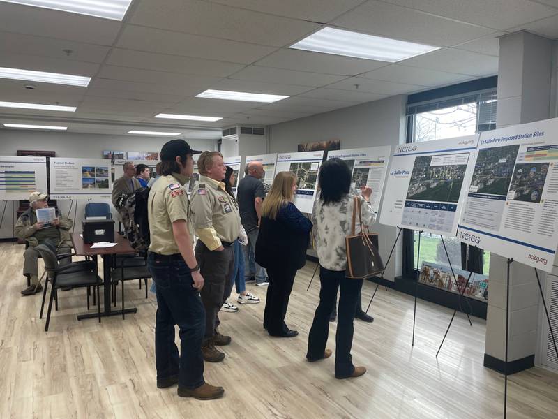 Utica residents study placards Tuesday, March 12, 2024, spelling out details of the Peoria-to-Chicago rail service. Utica would be included in the stops and some of those interviewed expressed hope rail access would boost tourism.
