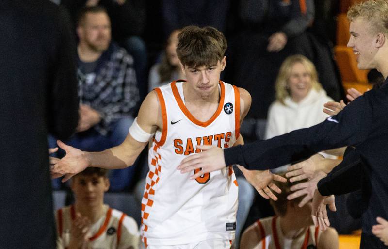 St. Charles East Guard Sam Tisch runs out during starting lineup announcers before a game against Marmion Academy on Saturday, Jan. 4, 2025.