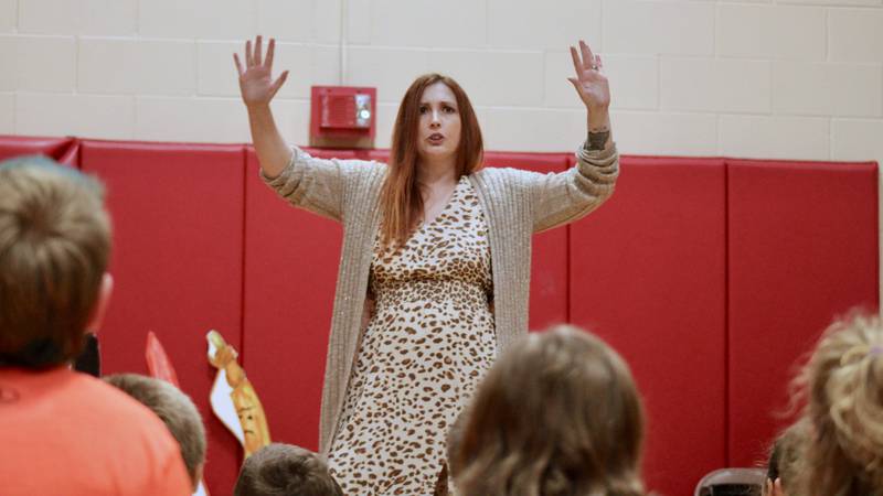 Amanda Fox, author of "Markertown" takes students at East Coloma Nelson School through the story of her children's book on Friday.