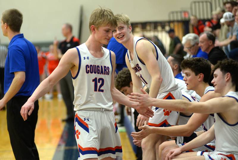 Eastland's Adam Awender (12) greets his teammates in the final seconds against South Beloit on Tuesday, Feb. 27, 2024 at the 1A River Ridge Sectional in Hanover. The Cougars beat South Beloit 50-25 to advance to the sectional championship.