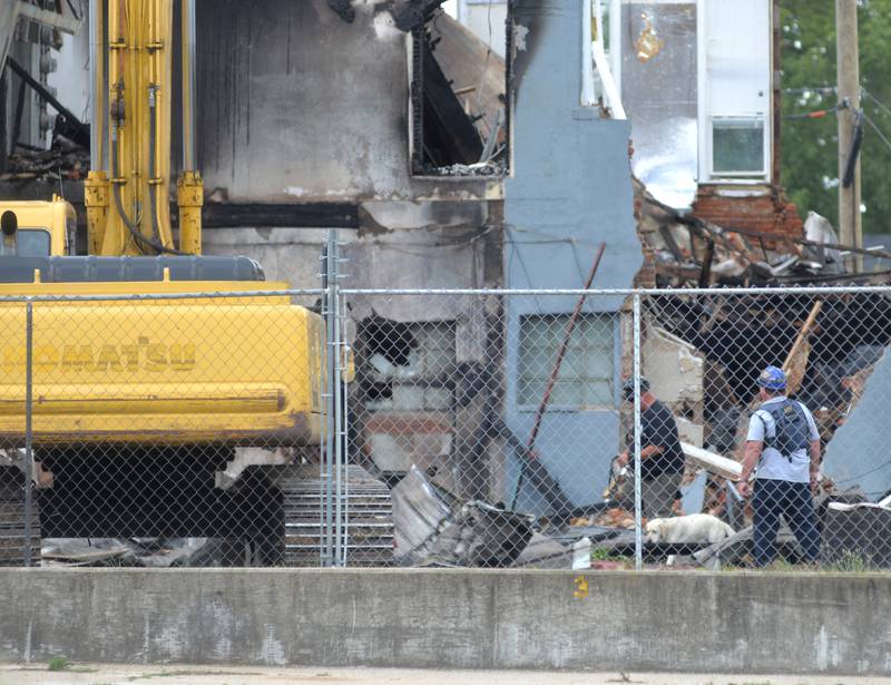 A search dog examines debris Tuesday, July 11, 2023, from a July 7 fire that destroyed an apartment building at 406 E. Third St. in Sterling.