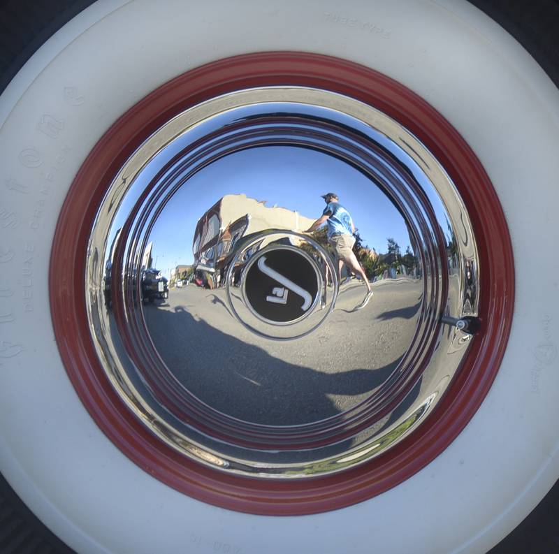 Those attending the Dream Machines Car Club’s Cruise Night were reflected in the hub cap of a classic car Saturday in Streator.