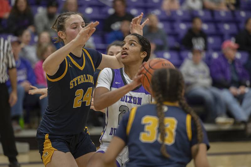 Dixon’s Ahmyrie McGowan works below the basket against Sterling’s Madison Austin Tuesday, Feb. 13, 2024 during a regional semifinal at Rochelle.