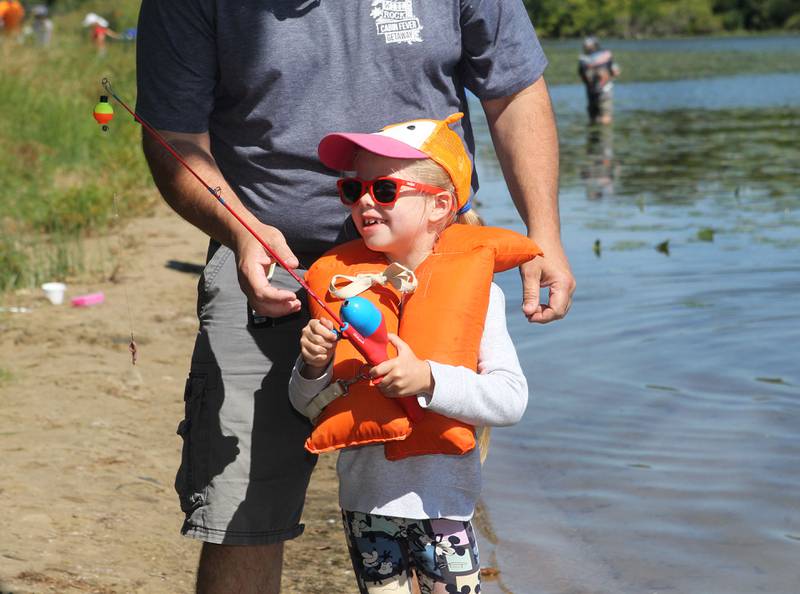 Brian Neff, of Round Lake teaches his daughter, Brynlee 6, how to cast before fishing off the shore of Round Lake during the Family Fishing Event at Lake Front Park on Saturday, September 9th in Round Lake Beach. Brynlee's brother, Caiden, 11, was also fishing at the event. 
Photo by Candace H. Johnson for Shaw Local News Network