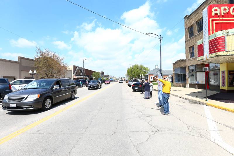 Jay Schneider, owner of the Apollo Theater in Princeton, drives by the Appolo Theatre during a special escort as supporters wave to him on Main Street in Princeton on Thursday April 29, 2021. Schneider was involved in a sledding accident in January. After over four months of rehabilitation, and multiple surgeries  Schneider was able to return home.