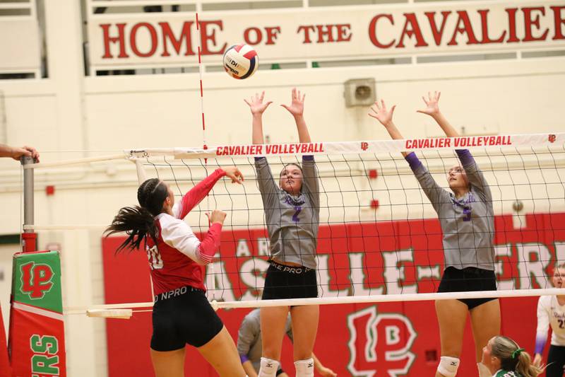 Rochelle's Jaydin Dickey (2) and Audyn Kemp (5) go up high for a block during the Hubs' match with La Salle-Peru.