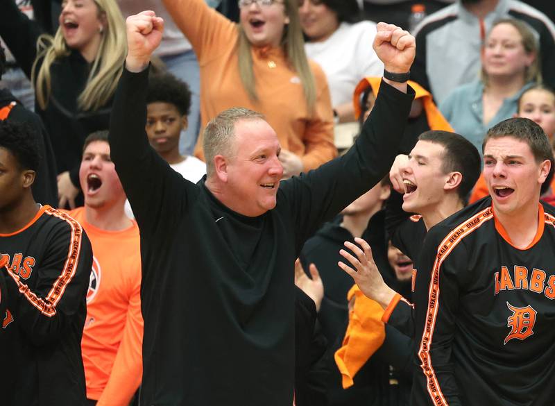 DeKalb Head Coach Mike Reynolds celebrates after his team beat Waubonsie Valley Friday, Feb. 21, 2025, at DeKalb High School.