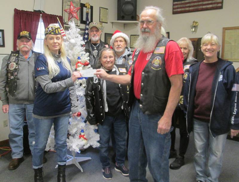 American Legion Riders Post #181 Director Bob Lawrence, right, presents a donation to Sandwich American Legion Commander, Celeste Latham. ALR members also pictured include Cliff Oleson, Bob Mauer, Sally & Bill Kolb, Cherie Mauer and Sandy Lawrence.