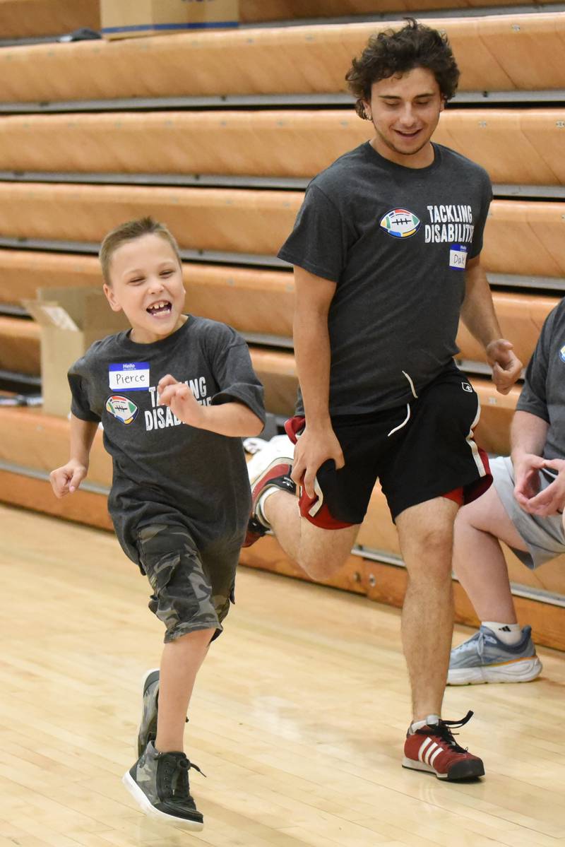 Pierce Storm, left, and Dale Hebert race during Watseka's Tackling Disabilities football camp Saturday, July 26, 2025.