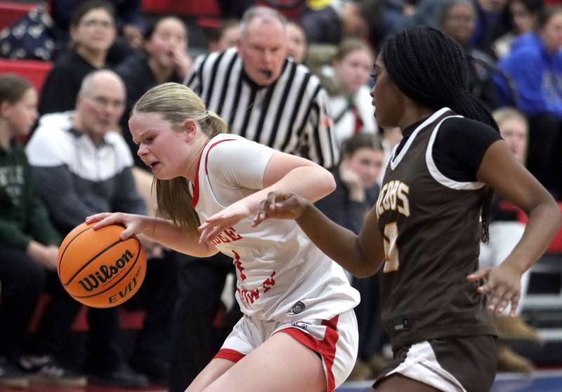 Jacobs’ Brylan Lemon, right, defends Dundee-Crown’s Josie Sheldon  in varsity girls basketball on Friday, Dec. 12, 2025, at Dundee-Crown High School in Carpentersville.