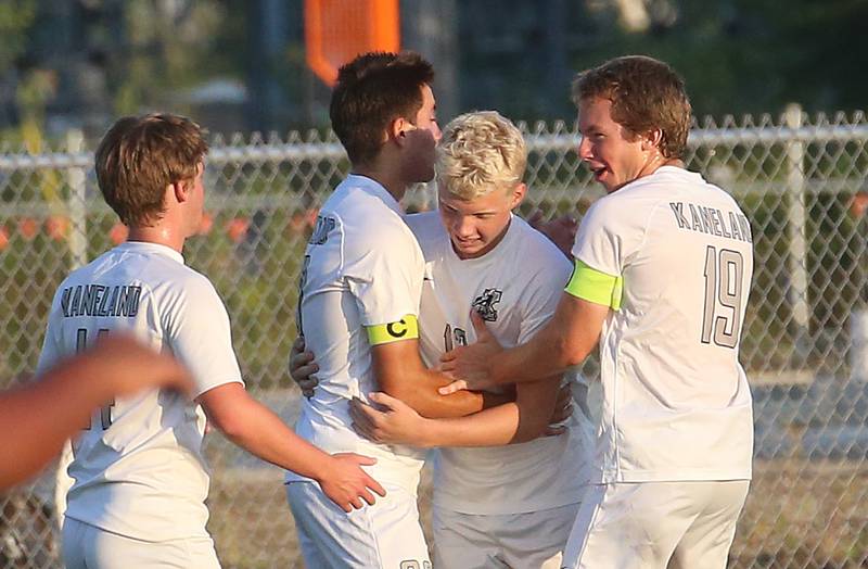 Kaneland players Nathan Scarpelli, Tommy Watson, and Michael Happ congratulate teammate SAm Keen on scoring a goal against L-P on Monday, Aug. 28, 2023 at the L-P Athletic Complex in La Salle.