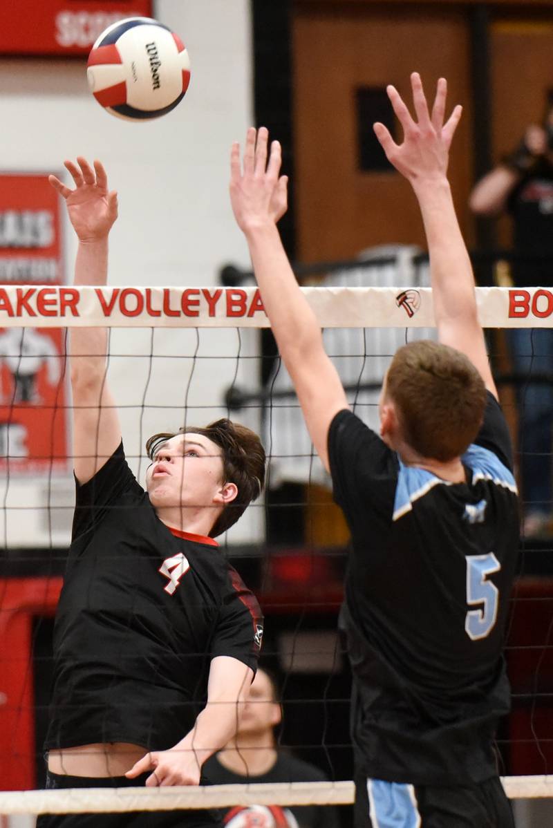Bradley-Bourbonnais' Cooper Yuska, left, looks to send a hit past Kankakee's Asa Chandler during a game at Bradley-Bourbonnais Thursday, April 9, 2026.