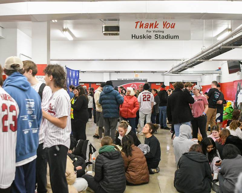 Spectators and Polar Plunge participants hangout inside Huskie Stadium in DeKalb to keep warm on Saturday Feb. 21, 2026, before making their way to the football field for the plunge.