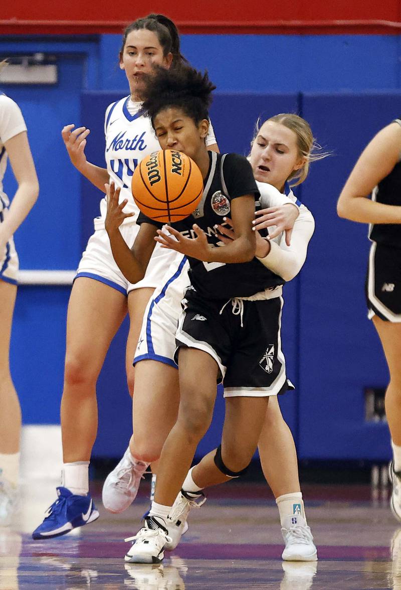 Fenwick's Eleanor Gibson (25) and St. Charles North's Brianna Buono (3) collide during the Dundee-Crown High School 41st Annual Komaromy Classic Friday, Dec. 27, 2024 in Carpentersville.