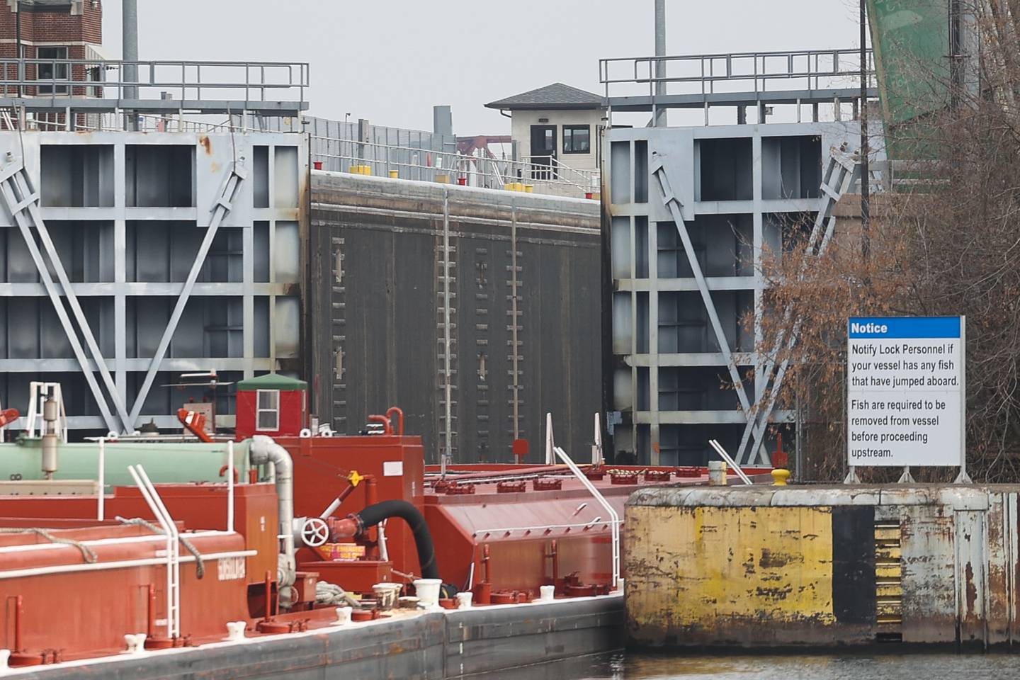 The U.S. Army Corps of Engineers plan to extend the Brandon Road Lock and Dam guide walls another 1,000 feet, seen in the background, and include deterrents to prevent upstream movement of invasive carp and other unwanted aquatic species.