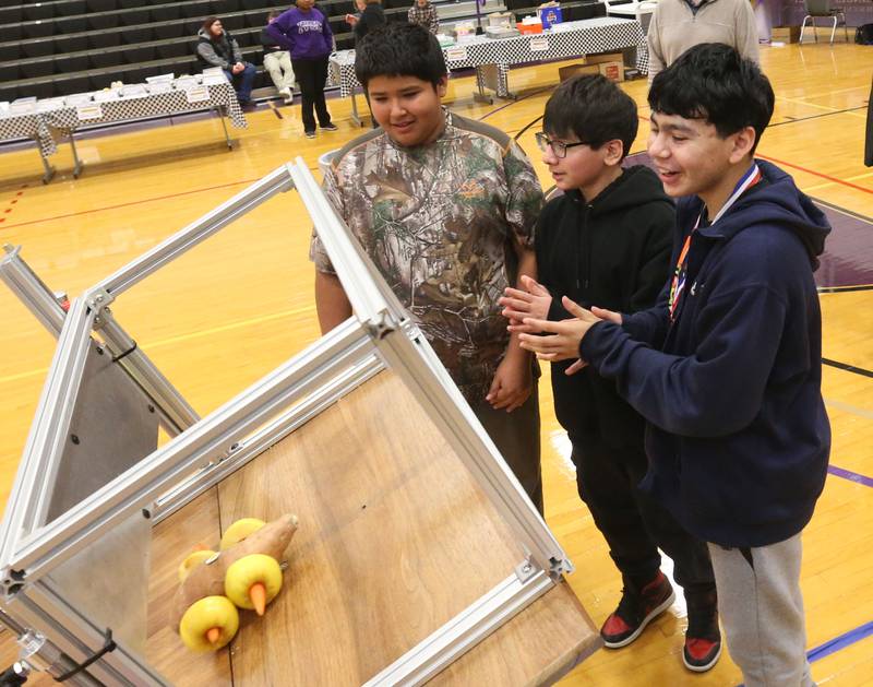 DePue students Cesar Morales, Mason Yuan and Noah Yanez places their car onto the mechanical ramp during the Edible Car Contest on Wednesday, Feb. 25, 2026 at Illinois Valley Community College in Oglesby.