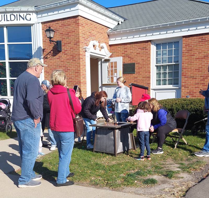 Families make s'mores Saturday, Nov. 18, 2023, during the Christmas Walk outside of the Prouty Building in Princeton.