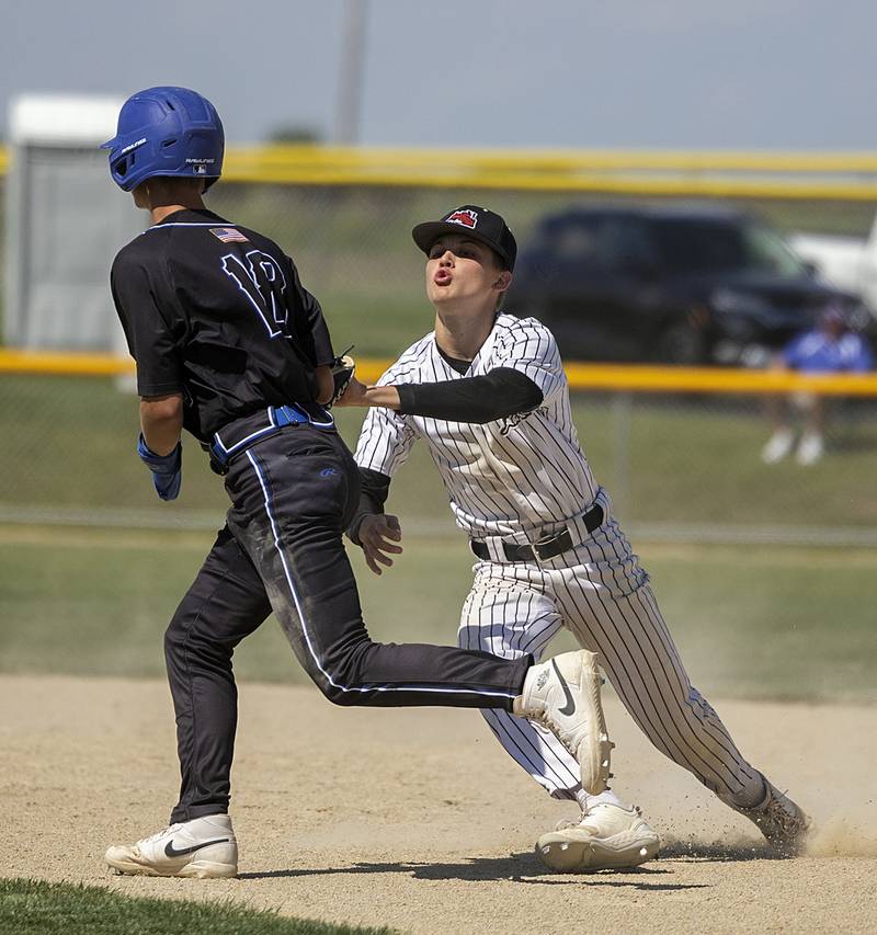 Fulton’s Caden Wilkin tags out  East Dubuque’s Spencer Sindahl Wednesday, May 22, 2024 in the Class A sectional semifinal in Forreston.