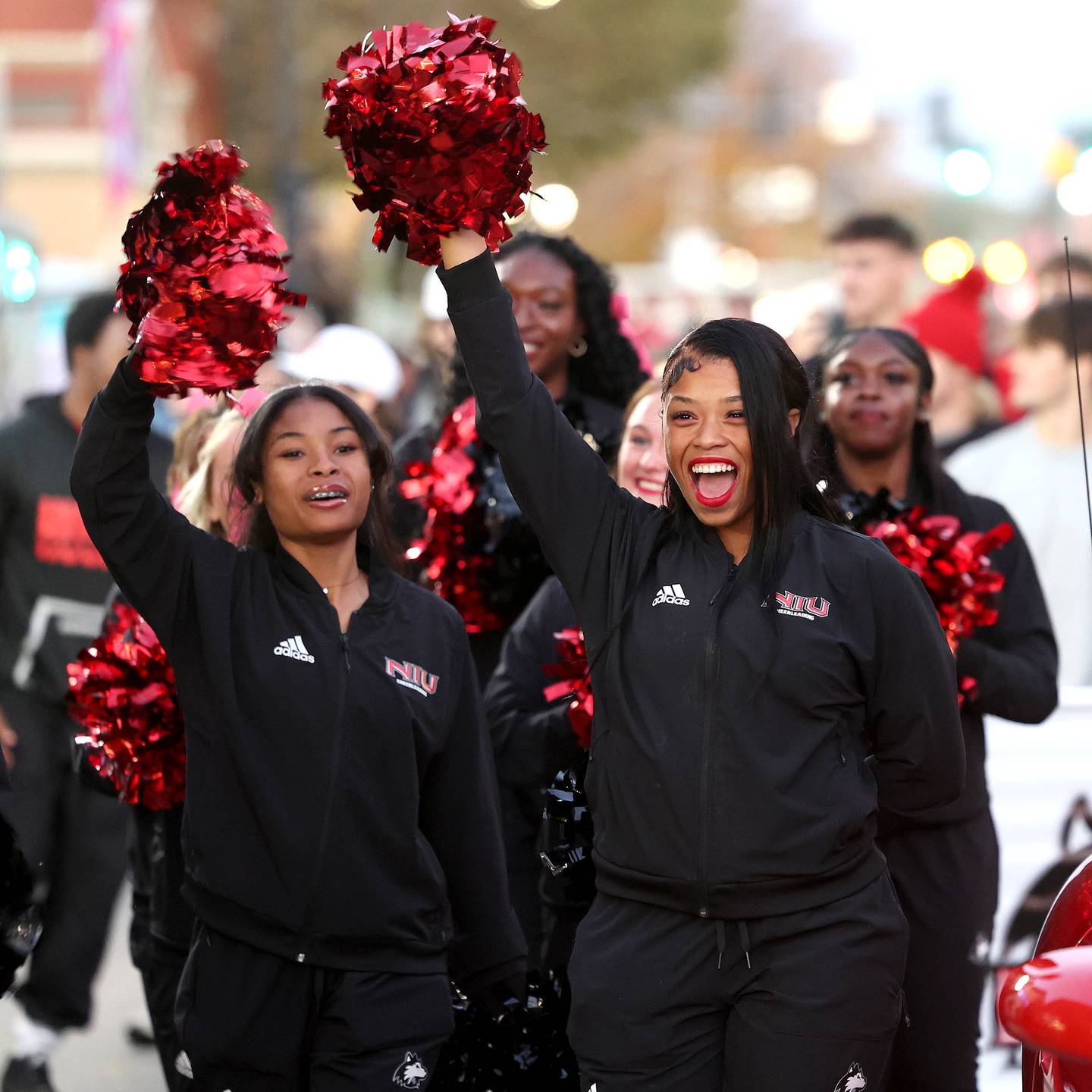 Northern Illinois University cheerleaders march through downtown DeKalb Thursday, Oct. 17, 2024, during the parade at the Huskie Homecoming Block Party