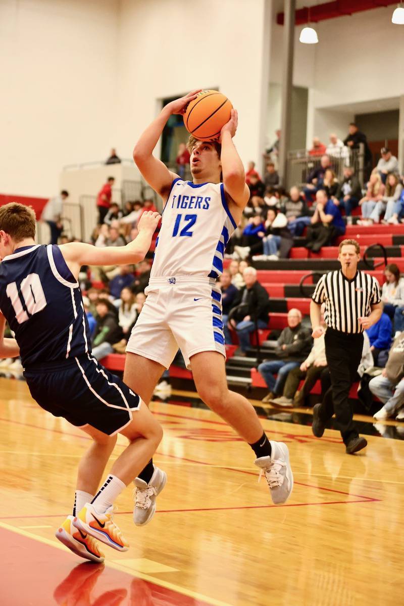 Princeton's Asa Gartin shoots over Fieldcrest's Kash Klendworth Tuesday night at Hall High School.