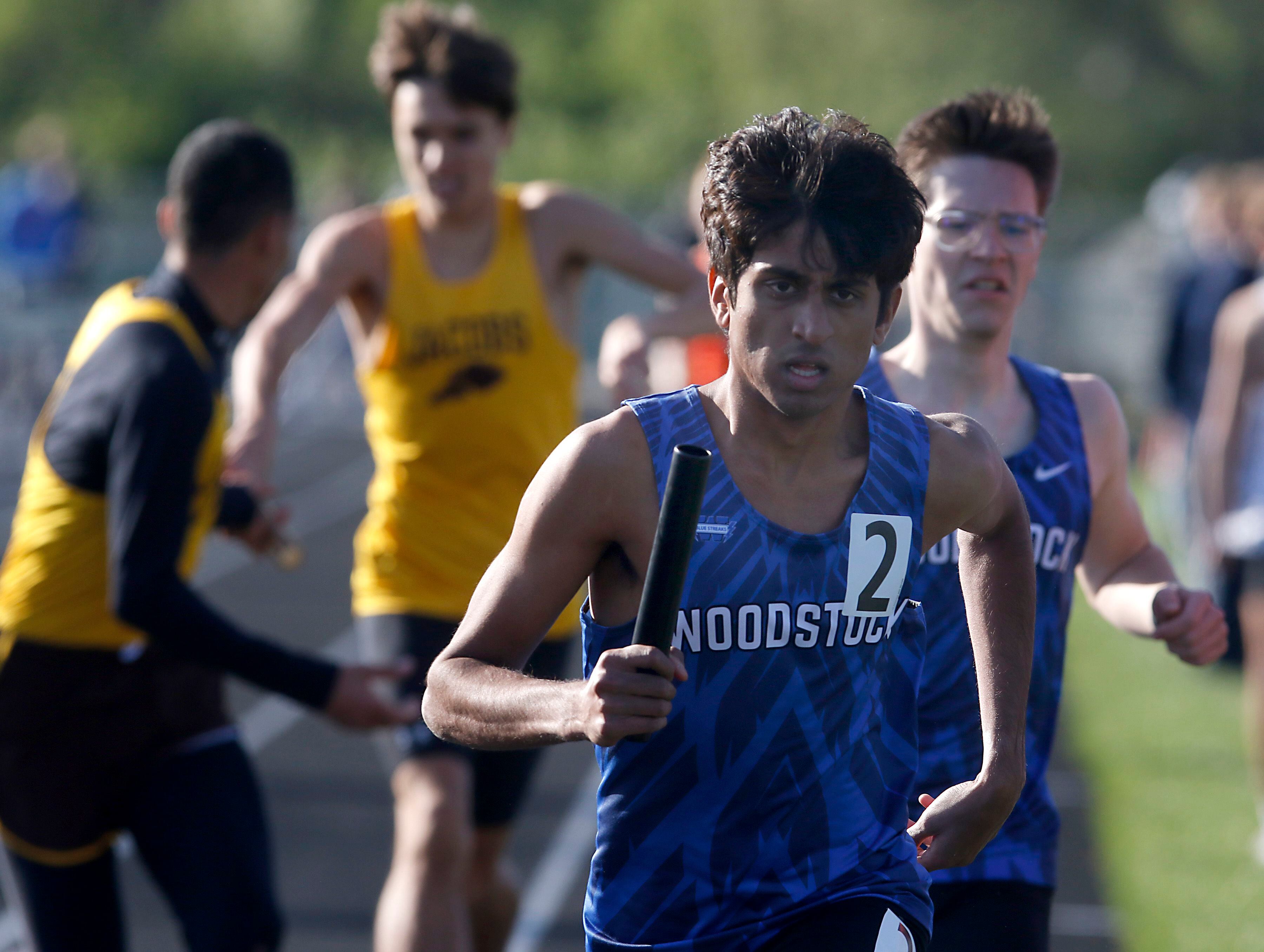Woodstock’s Ishan Patelon takes off after getting the baton for the last leg of the 4 x 800m meter relay on Friday, April 19, 2024, during the McHenry County Track and Field Meet at Cary-Grove High School.