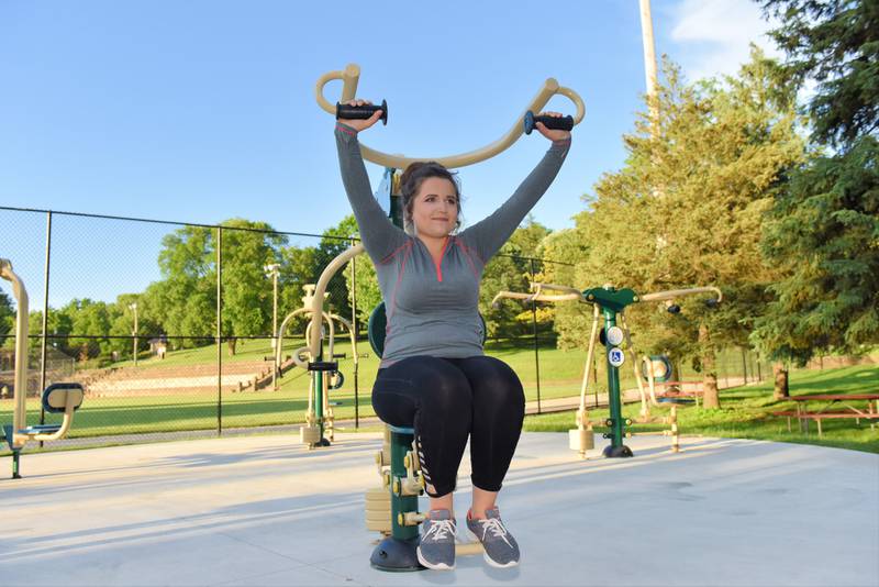 Jenny Frankowski of South Elgin works out using the free outdoor fitness equipment in Pottawatomie Park.