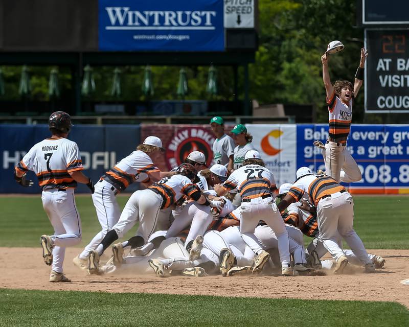 The team mobs McHenry's Ricky Powell (22) after hitting the game winner to defeat York in the Class 4A Supersectional game.  June 7, 2022.