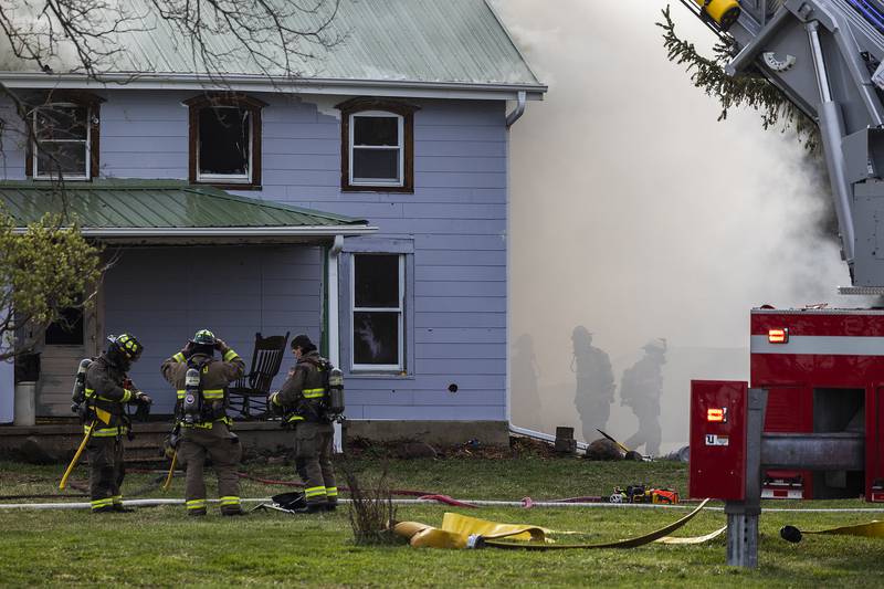 Firefighters battle a house fire Monday, April 14, 2025, at 1308 Harmon Road.