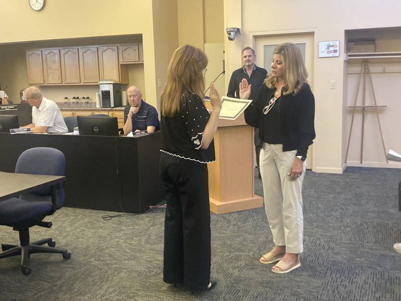 Mayor Steven Streit watches as Susan King is sworn in as Lockport's new 1st Ward Alderman.
