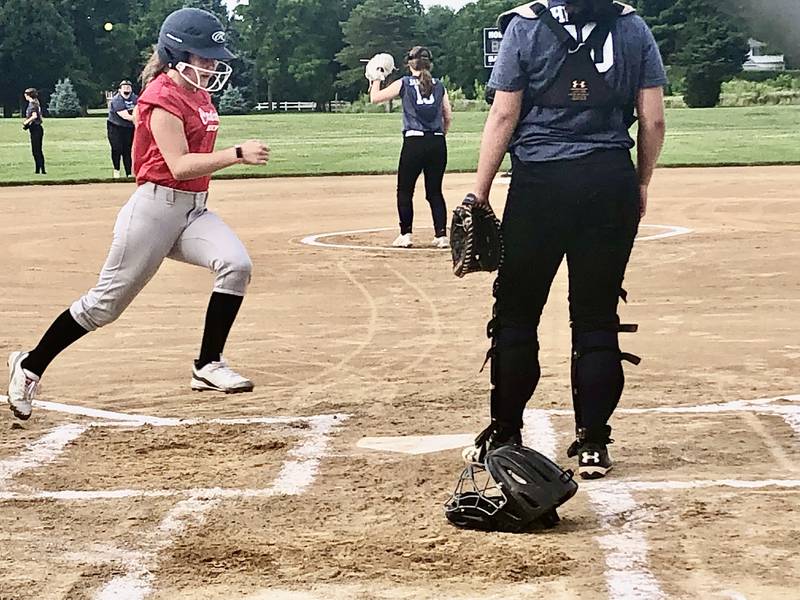 Gabby Carden of the Princeton Cardinals scores a run against Walnut in Wednesday's B League Tournament acton at Zearing Park. The Cardinals won 5-2.