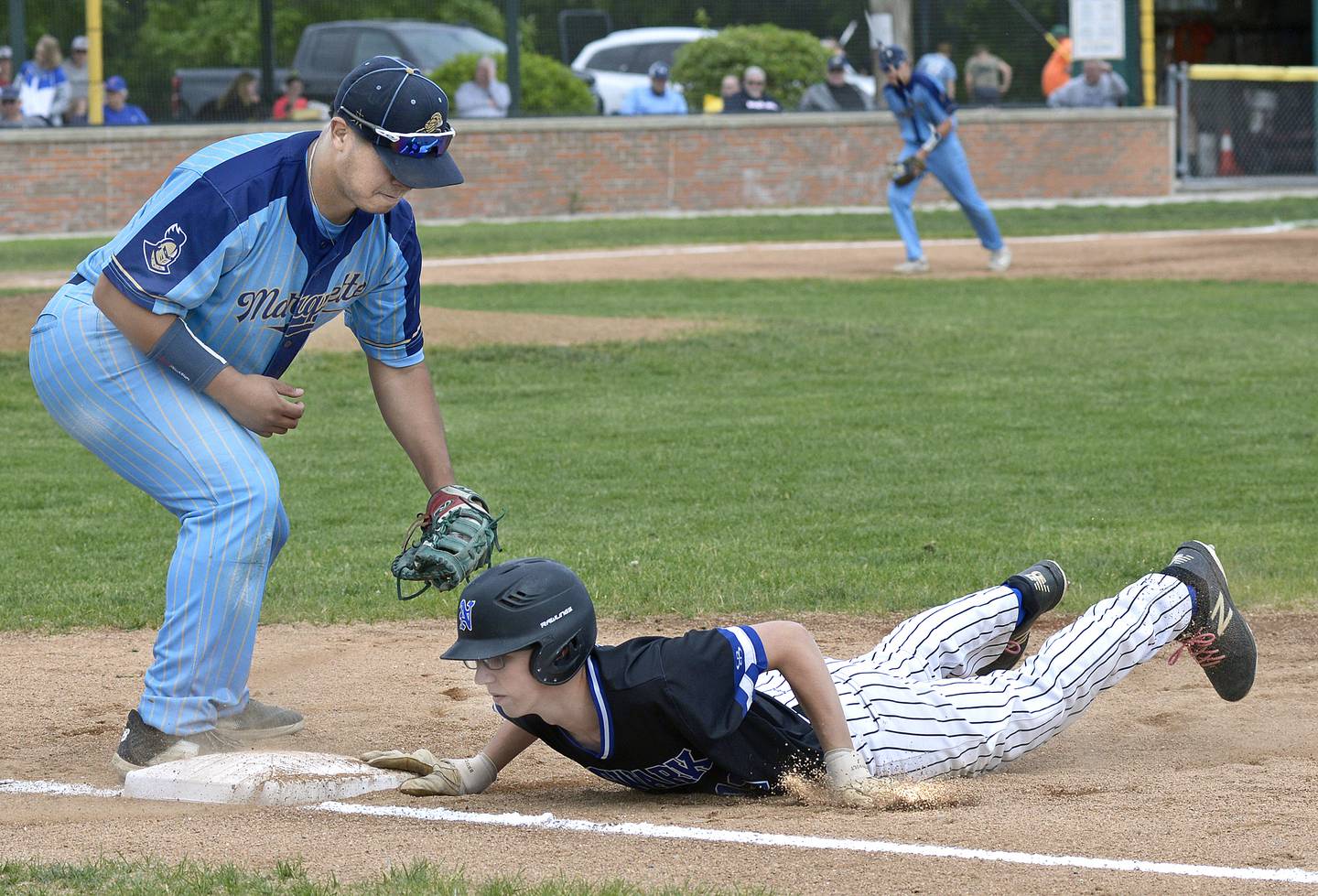 Marquette’s Sam Mitre places the tag late on Newark’s David Ulrich during a pickoff attempt at first base Saturday at Masinelli Field.
