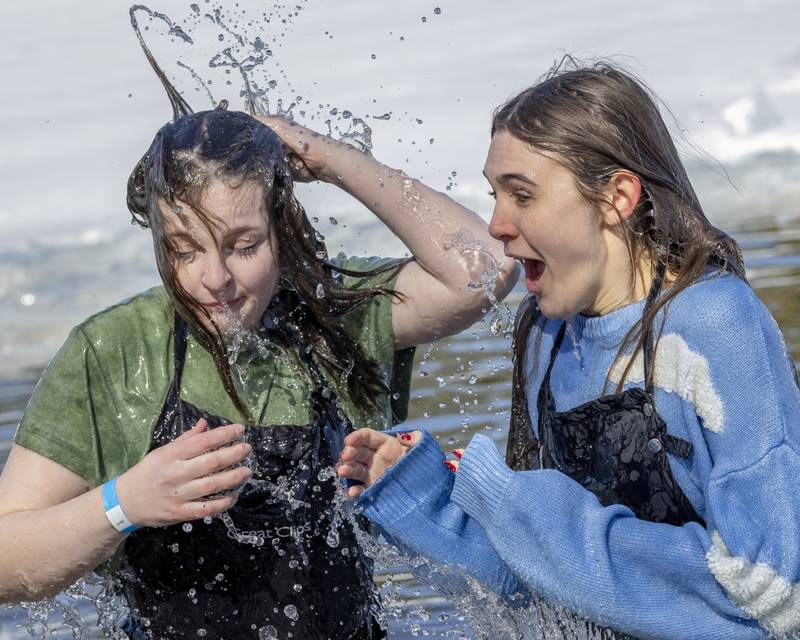Participants from the Great Clips plunge team react after getting up out of the frigid lake during the Polar Plunge for Special Olympics on February 22, 2025 at Lake Mendota.