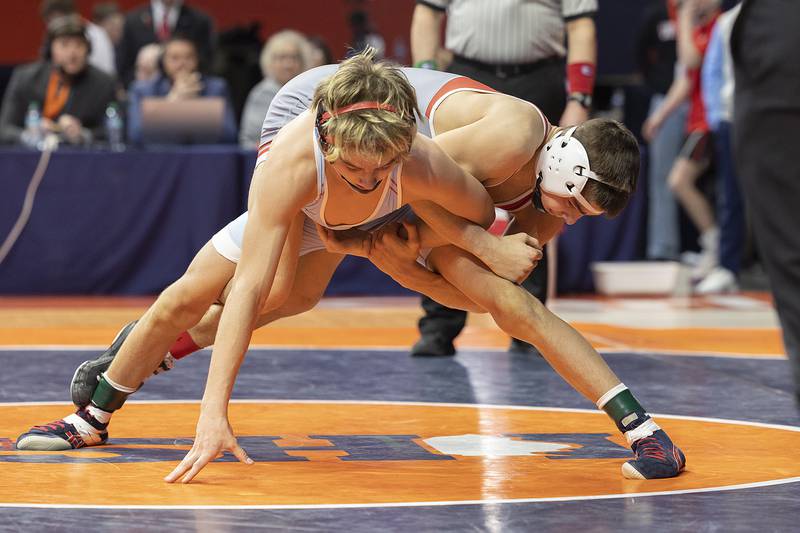 Marian Central’s Austin Hagevold and Vandalia’s Max Philpot (top) compete in the 113 pound weight class of the 1A state individual wrestling finals Saturday, Feb. 22, 2025, at State Farm Center in Champaign.