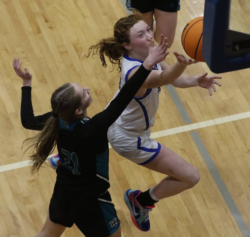 Woodstock's Keira Bogott drives tot basket against Woodstock North's Abigail Ward during a Kishwaukee River Conference basketball game on Friday, Jan. 10, 2025, at Woodstock High School.