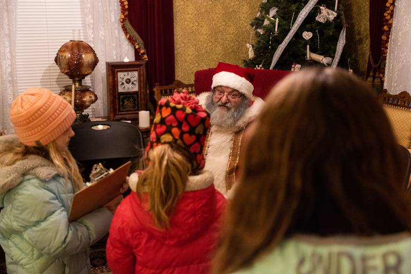 Santa talks to Avery, right, Isla, middle, and Teagan during a Merry & Bright Victorian Christmas at the Downers Grove Museum on Saturday, Dec. 14, 2024.