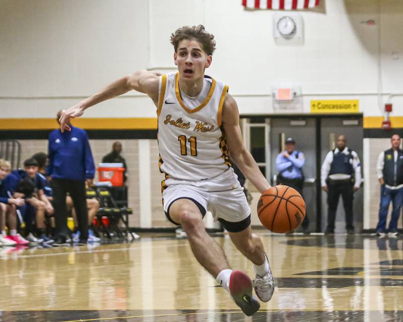 Joliet West's Luke Grevengoed (11) drives down the lane during their basketball game between Plainfield South at Joliet West, Feb 2, 2026 in Joliet.