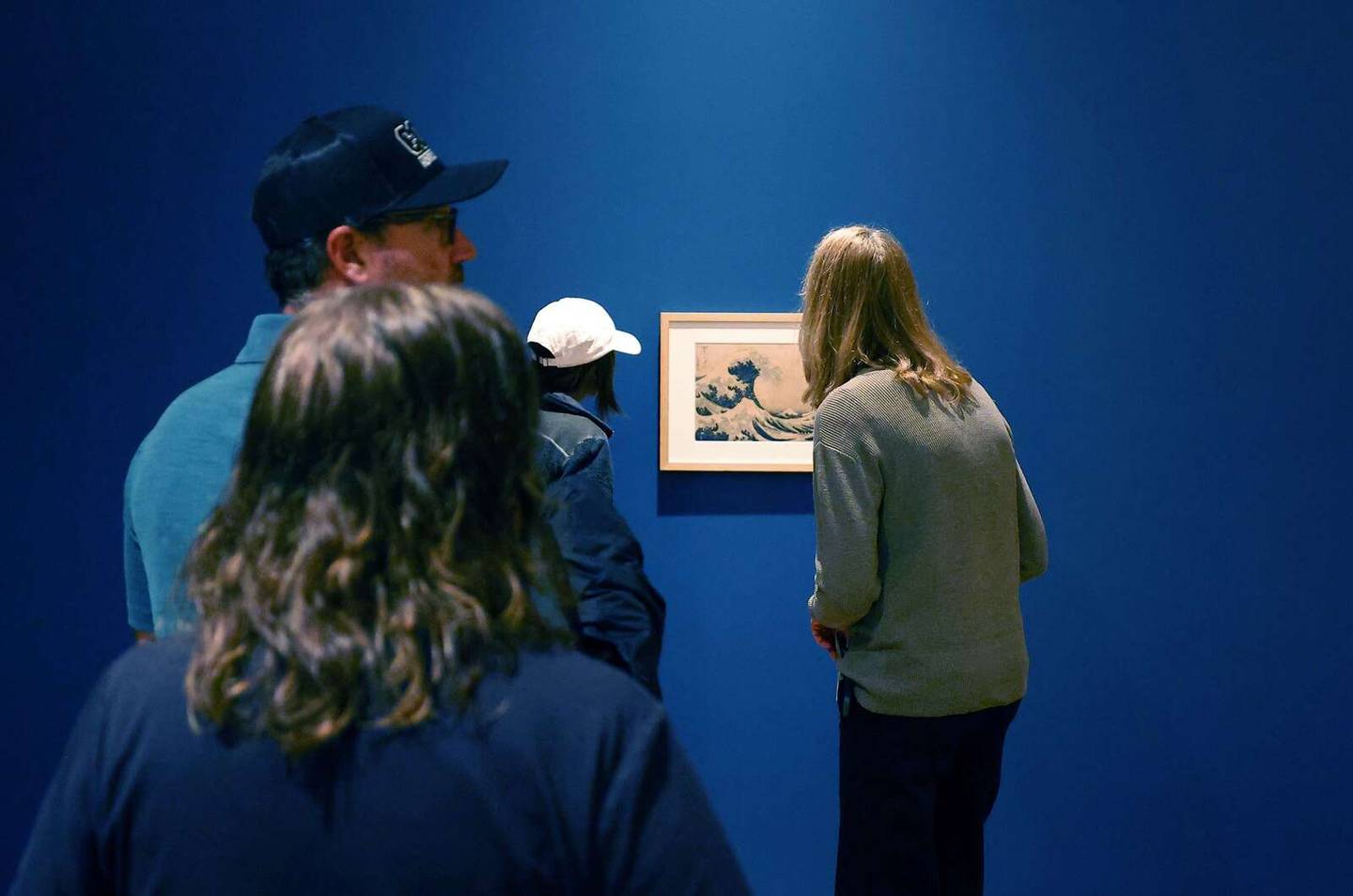 People get a close-up view of “The Great Wave” during a preview of the “Hokusai and Ukiyo-e: The Floating World” exhibition Wednesday at the McAninch Arts Center on the campus of the College of DuPage in Glen Ellyn.