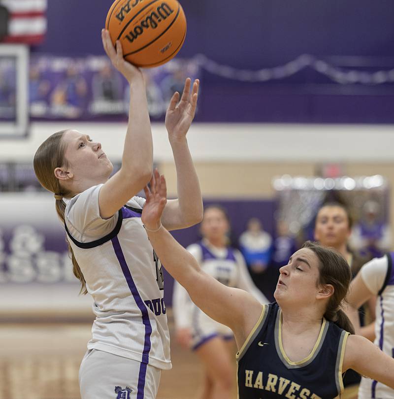 Dixon’s Sophia Wendt scores a pair against Harvest-Westminster’s Diana Dinapoli Wednesday, Feb. 11, 2026.