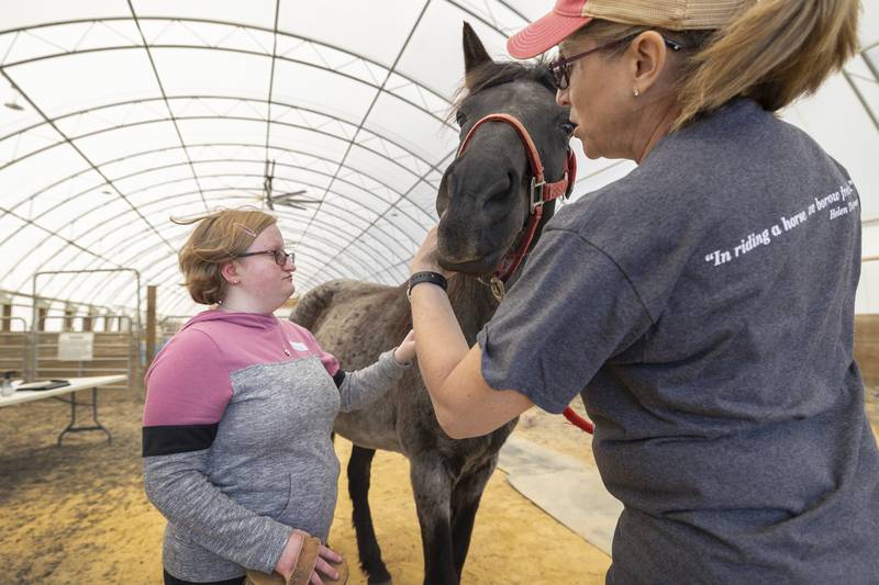 Hannah and PSR board president Stacy Seaworth work with an animal Tuesday, May 6, 2025, at Pegasus Special Riders in Oregon.