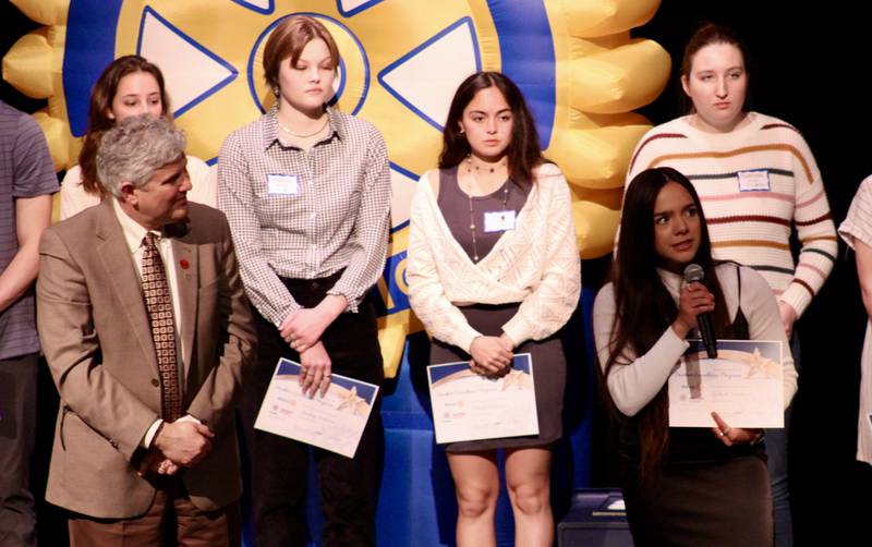Lizbeth Valdivia, a senior at Sterling High School shares her plans for college while Sterling Noon Rotary President Dave Hellmich listens as part of the 37th Student Excellent Program held Wednesday at Centennial Auditorium.