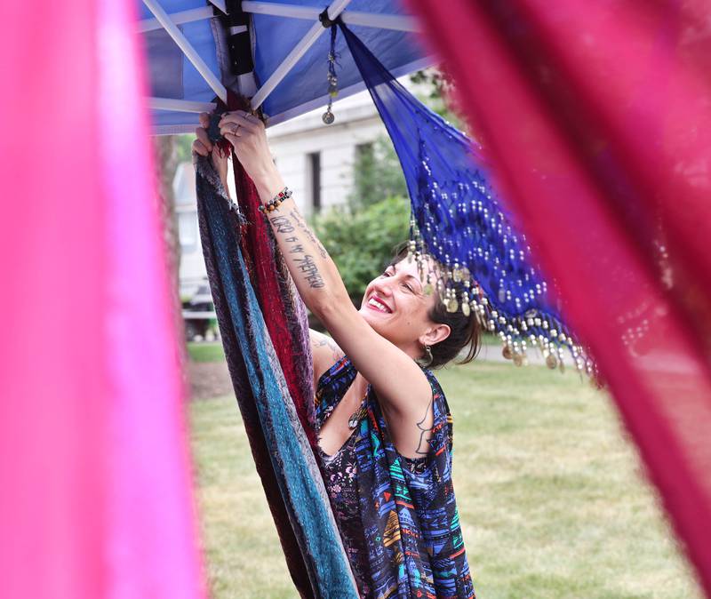 Leslie Lines, from Gypsy Jams and Creations, spruces up her tent Tuesday, June 6, 2023, at the Sycamore Farmers’ Market, on the lawn of the DeKalb County Courthouse.