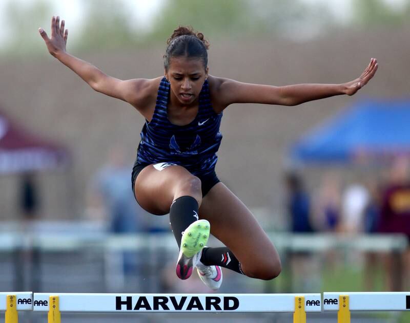 Woodstock’s Amina Idris clears the final hurdle in winning the 300-meter hurdles during the Kishwaukee River Conference Girls Conference Championships track meet at Harvard High School Tuesday.