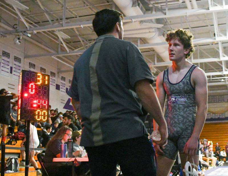 Gio Diaz of Plano talks to one of his coaches after pinning opponent of Hoopston with 44 seconds left in the first round Saturday Dec. 10th to get 5th place during the Plano Reaper wrestling classic held at Plano High School.